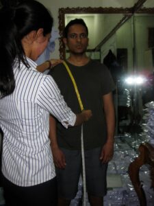 a woman measuring a man's waist
