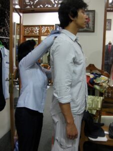 a woman adjusting a man's shoulder
