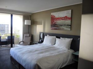 a bed with white sheets and pillows
