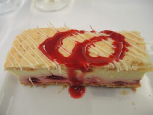 a piece of cake with red sauce