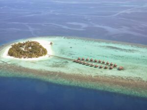 an island with huts in the ocean