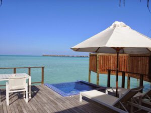 a deck with a pool and umbrella