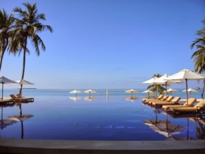 a pool with umbrellas and lounge chairs
