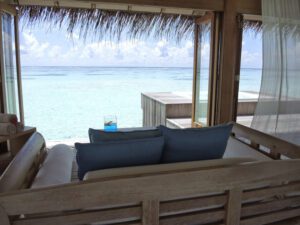a couch on a deck overlooking the ocean