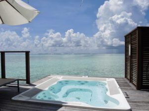a hot tub on a dock overlooking the ocean