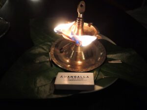 a lit oil lamp on a leaf