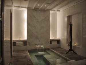a small indoor pool with a waterfall
