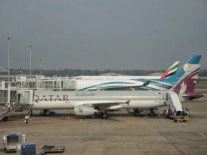 a group of airplanes parked at an airport