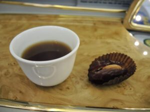 a cup of coffee and a chocolate candy