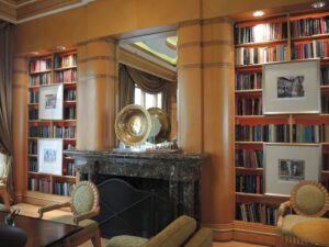 a room with a fireplace and bookshelves