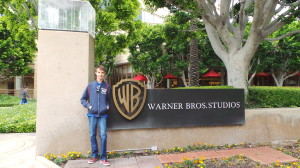 a man standing next to a sign