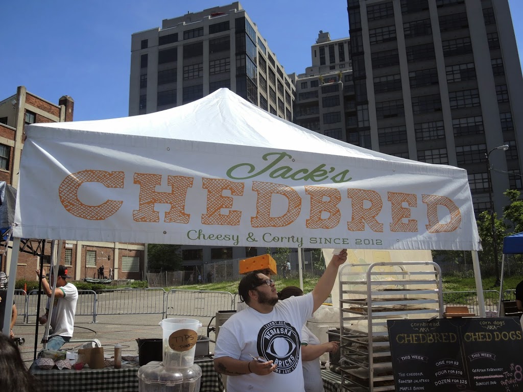a man holding a sign under a tent