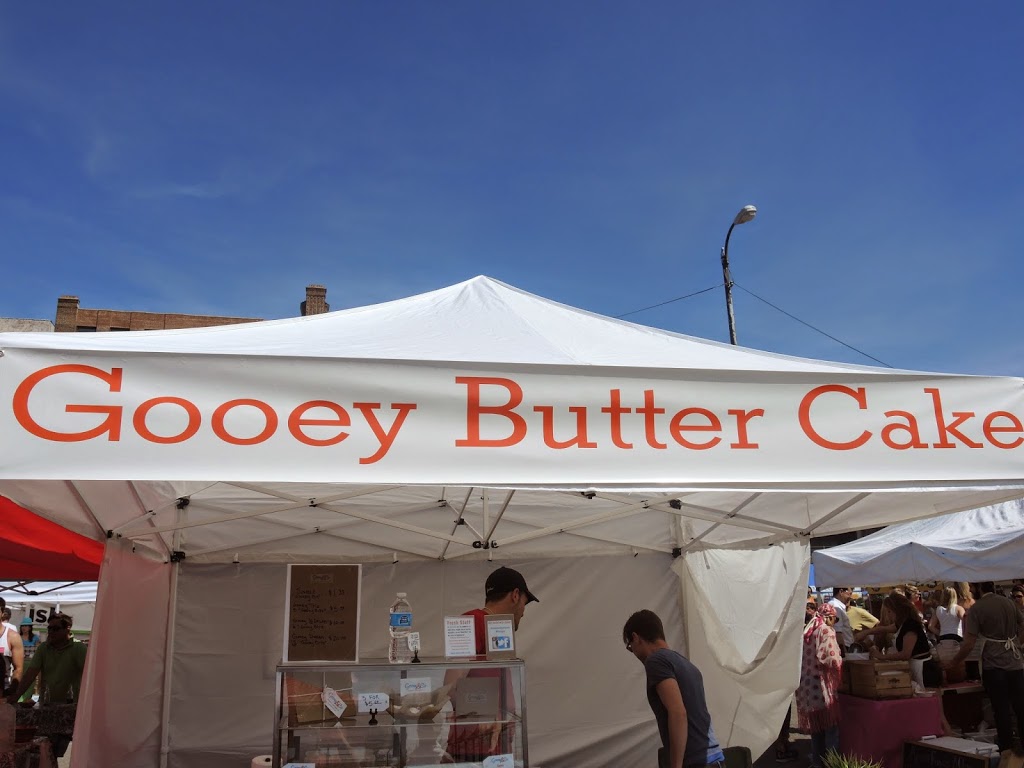 a white tent with red text and a man standing in front of it