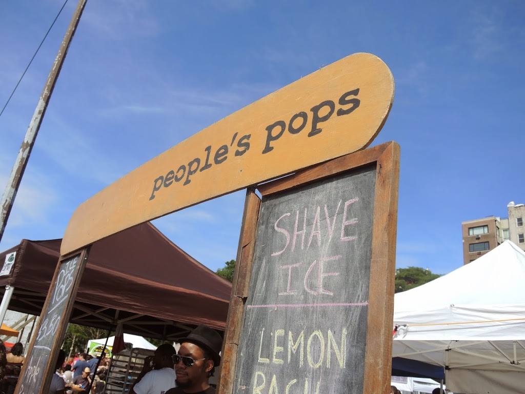 a sign with a person standing behind it