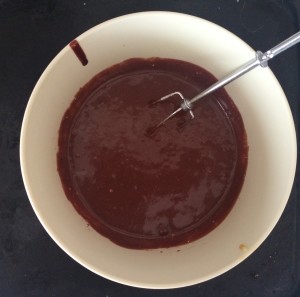 a bowl of brown liquid with a fork