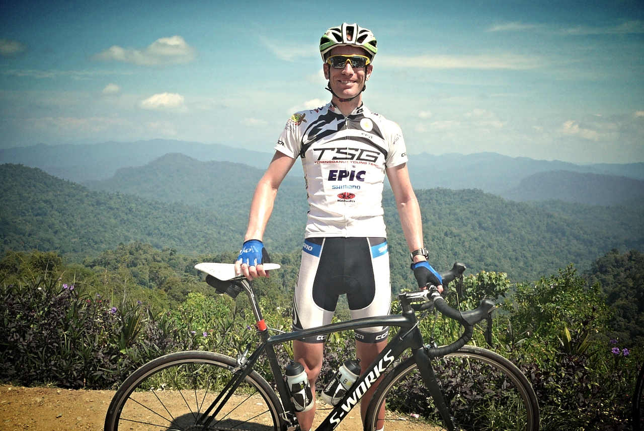 a man standing on a mountain bike