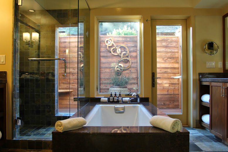a bathroom with a bathtub and glass doors