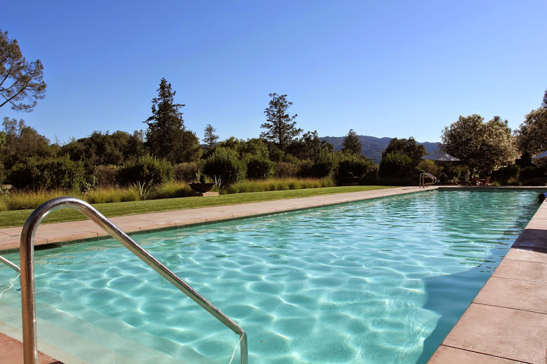 a swimming pool with a metal railing