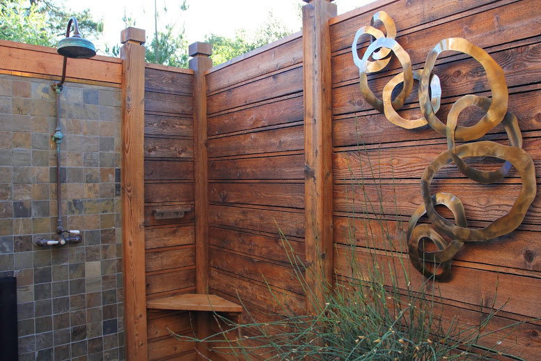 a wood wall with a metal sculpture