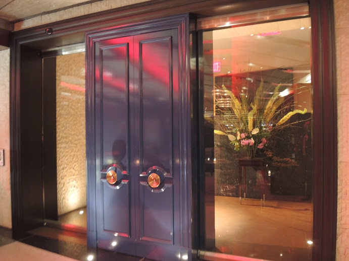 a glass door with a vase of flowers in it