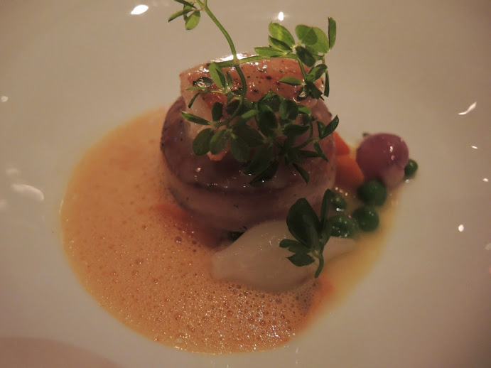 a plate of food with a sprig of herbs