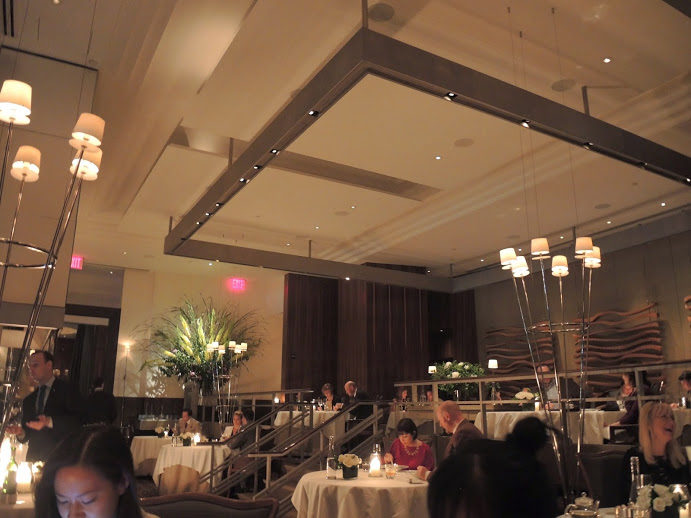 a group of people sitting at tables in a restaurant