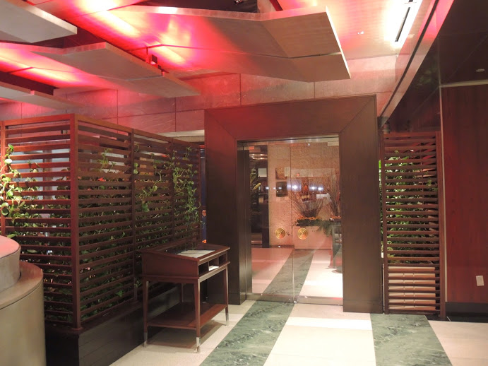 a room with a glass door and a wooden screen