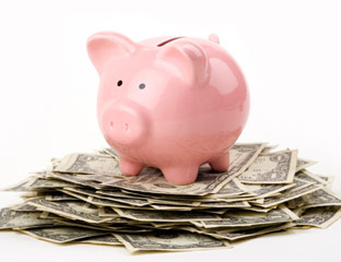 a piggy bank on top of money