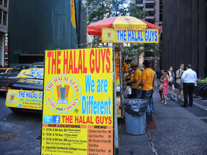 a yellow sign with blue text and white text on it