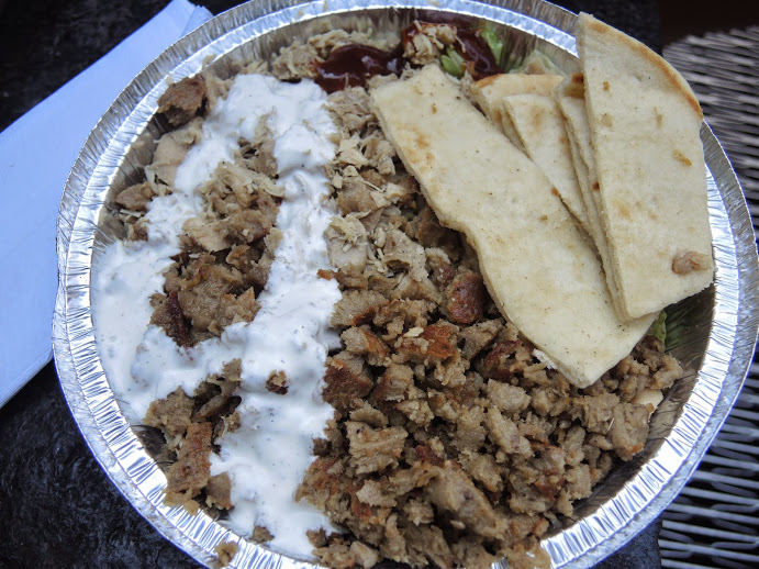 a plate of food with pita bread and meat