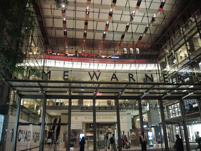 a glass building with a sign