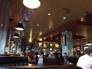 a group of people sitting at tables in a restaurant
