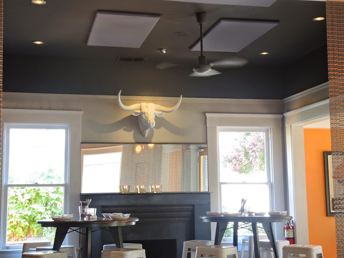 a room with a fireplace and a bull head on the wall