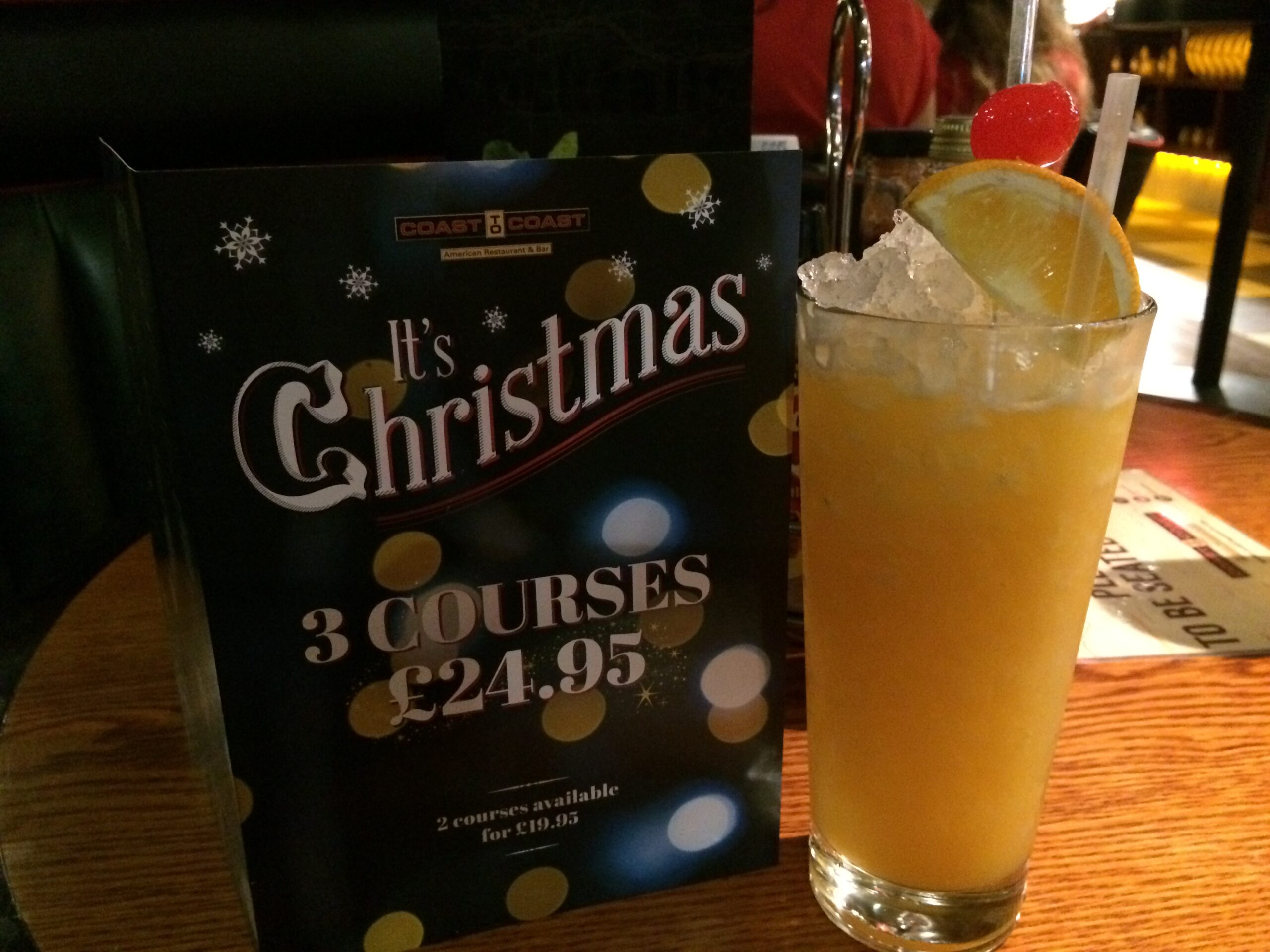 a drink and a sign on a table