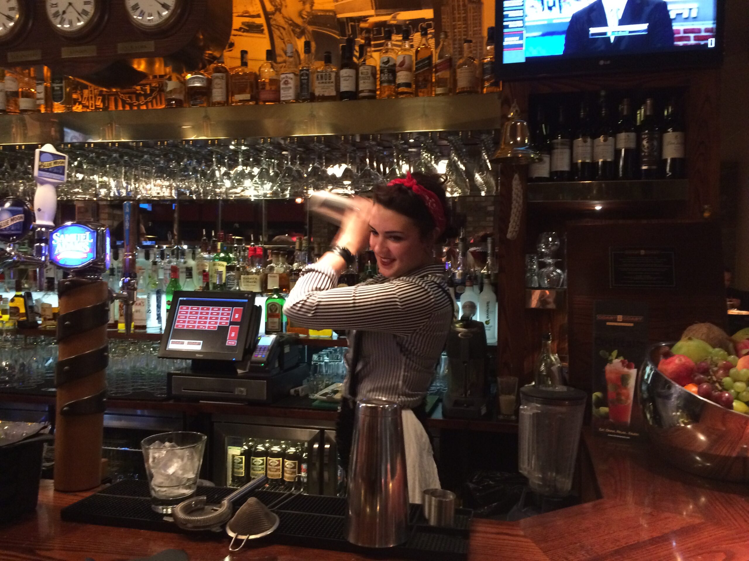 a woman standing behind a bar