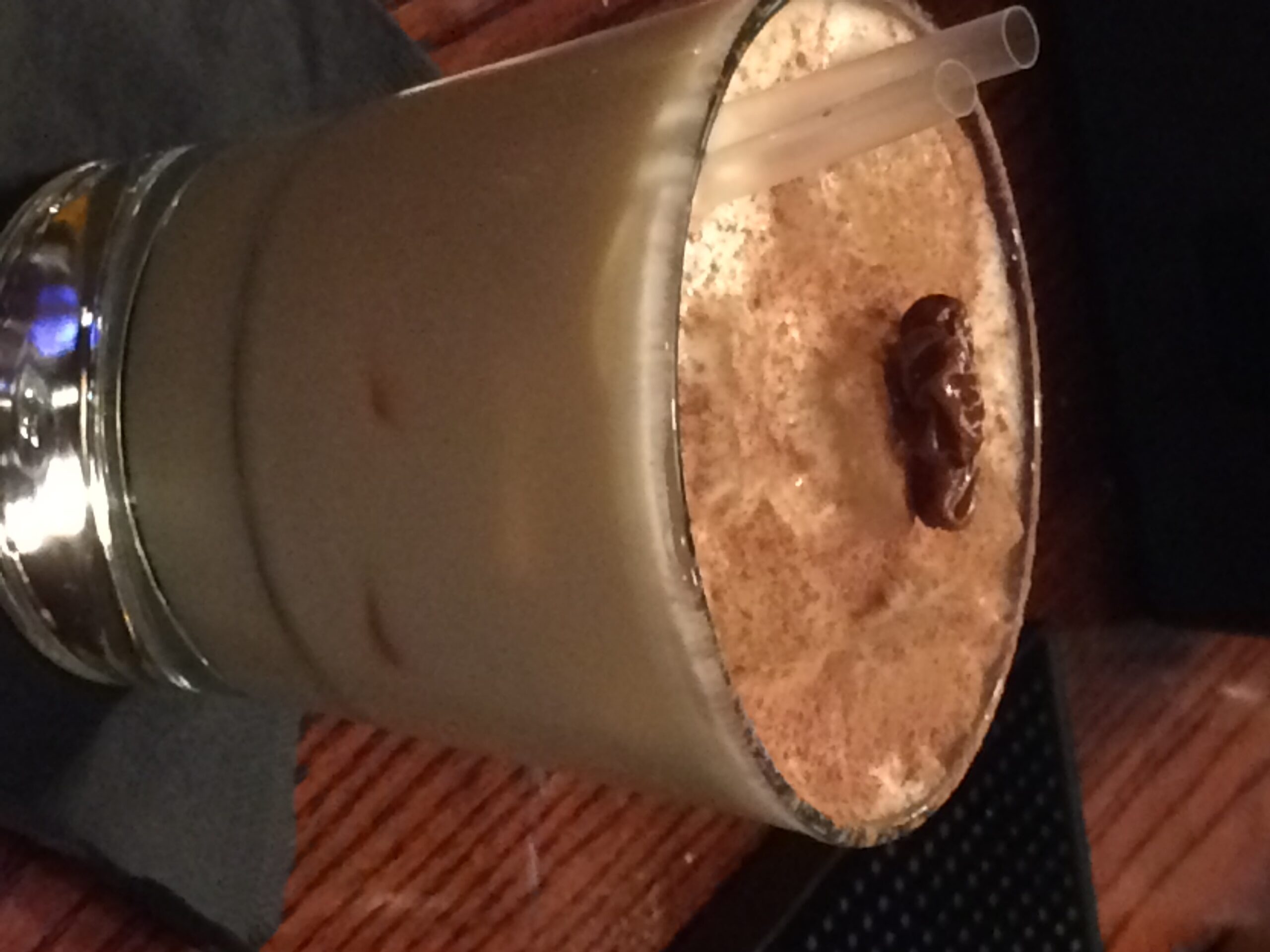 a glass of milkshake with straws