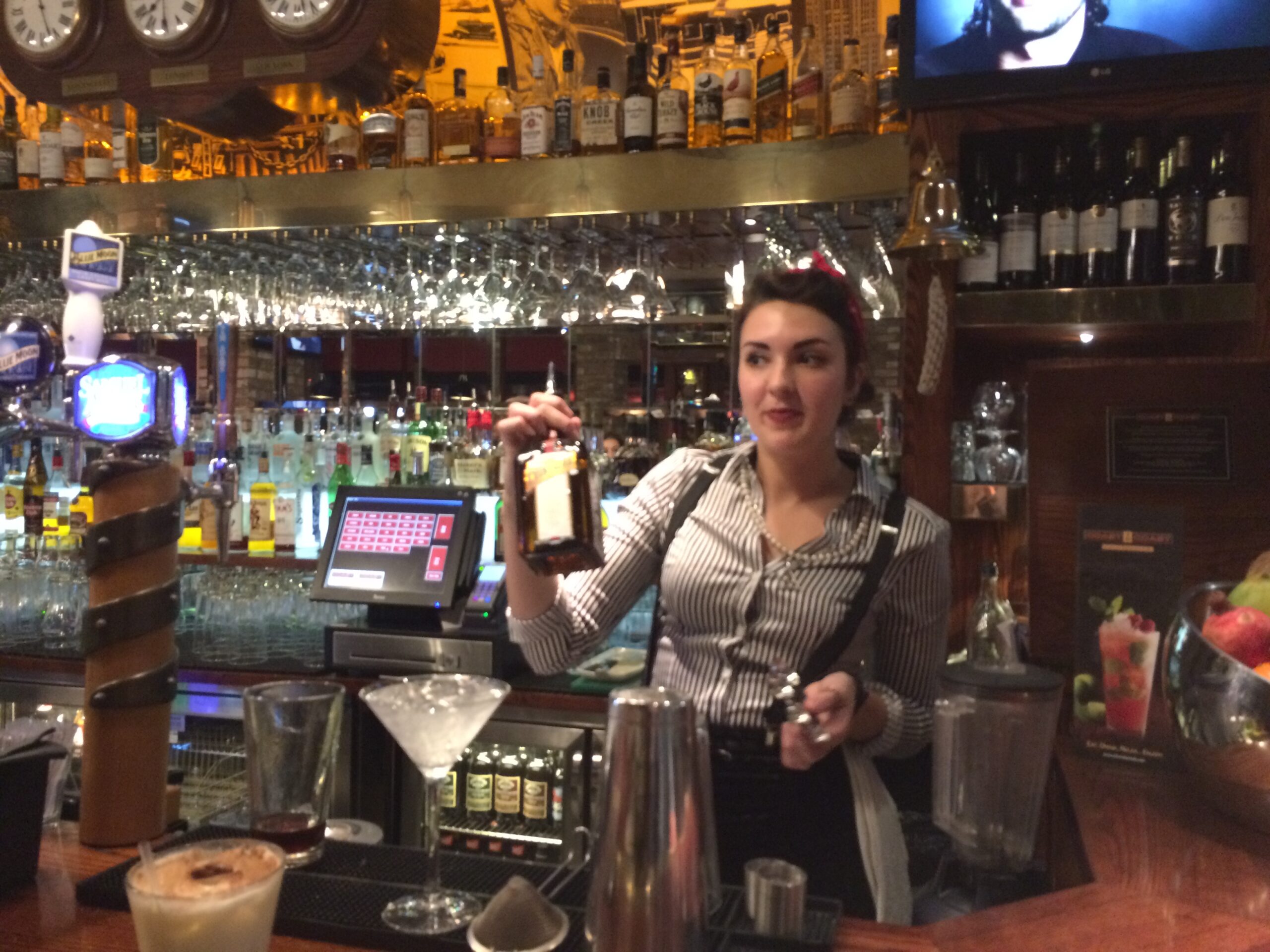 a woman holding a bottle of alcohol