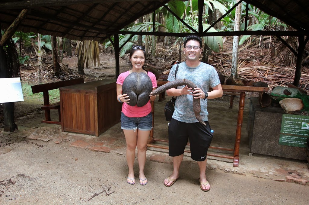 a man and woman holding a large snake