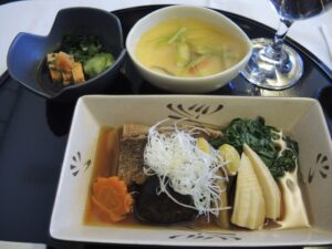 a bowl of soup and a glass of wine