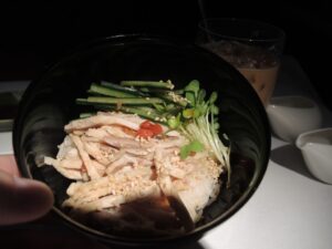 a bowl of food with a hand