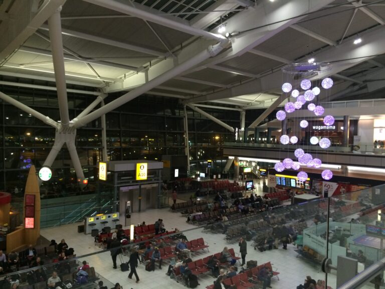 a group of people sitting in chairs in an airport