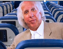 a man in a suit sitting in a plane