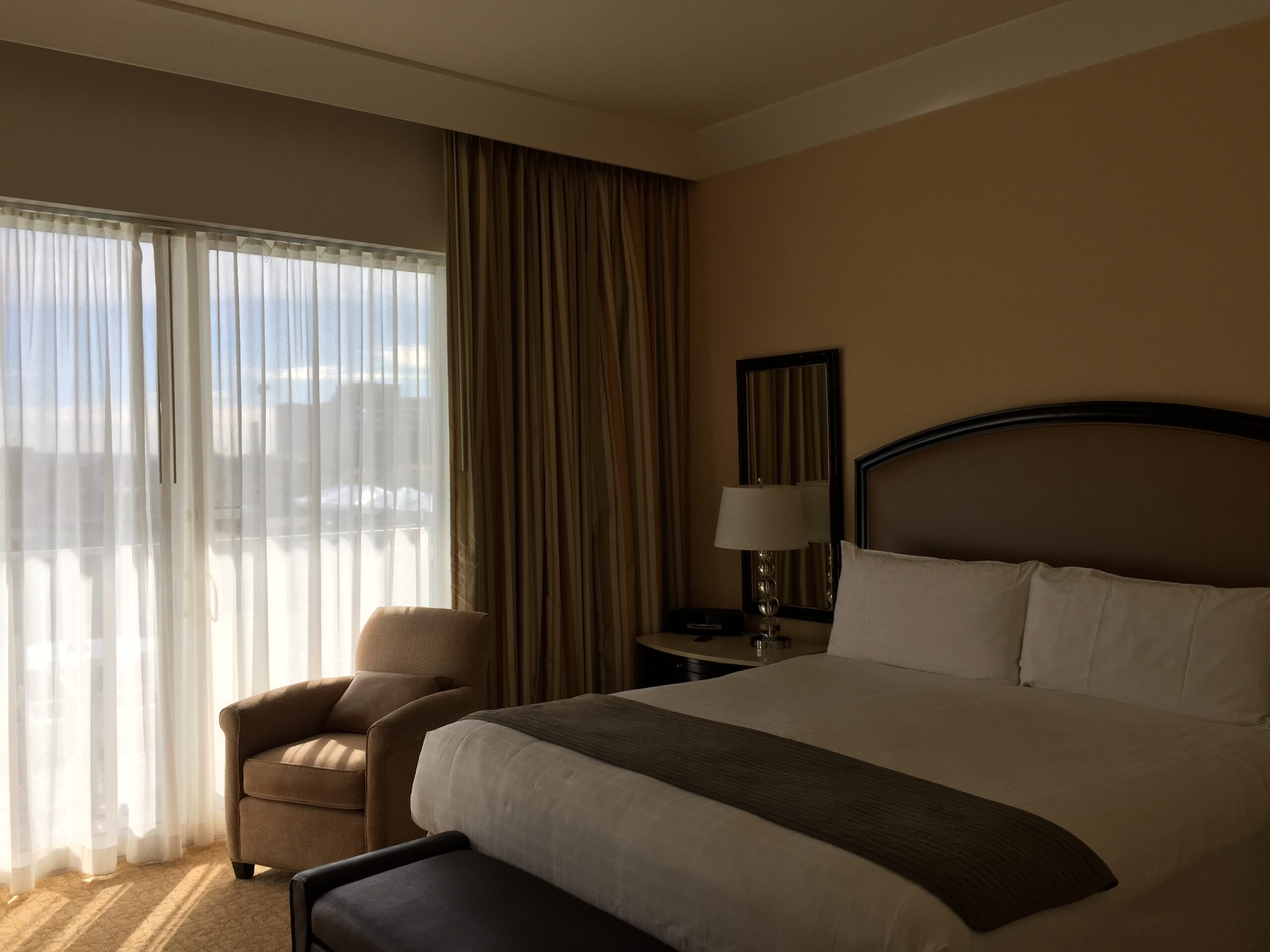 a bedroom with a bed and a chair