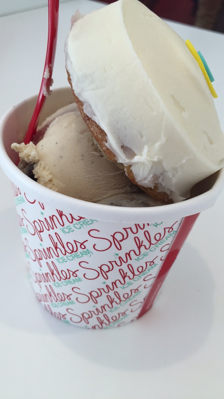 a cup of ice cream with a cookie and a cookie on top