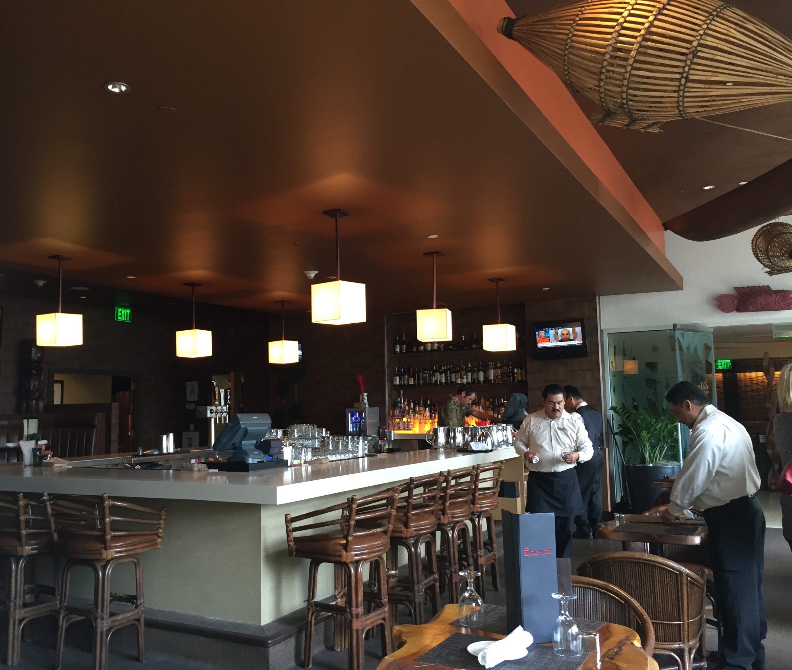 people standing around a bar