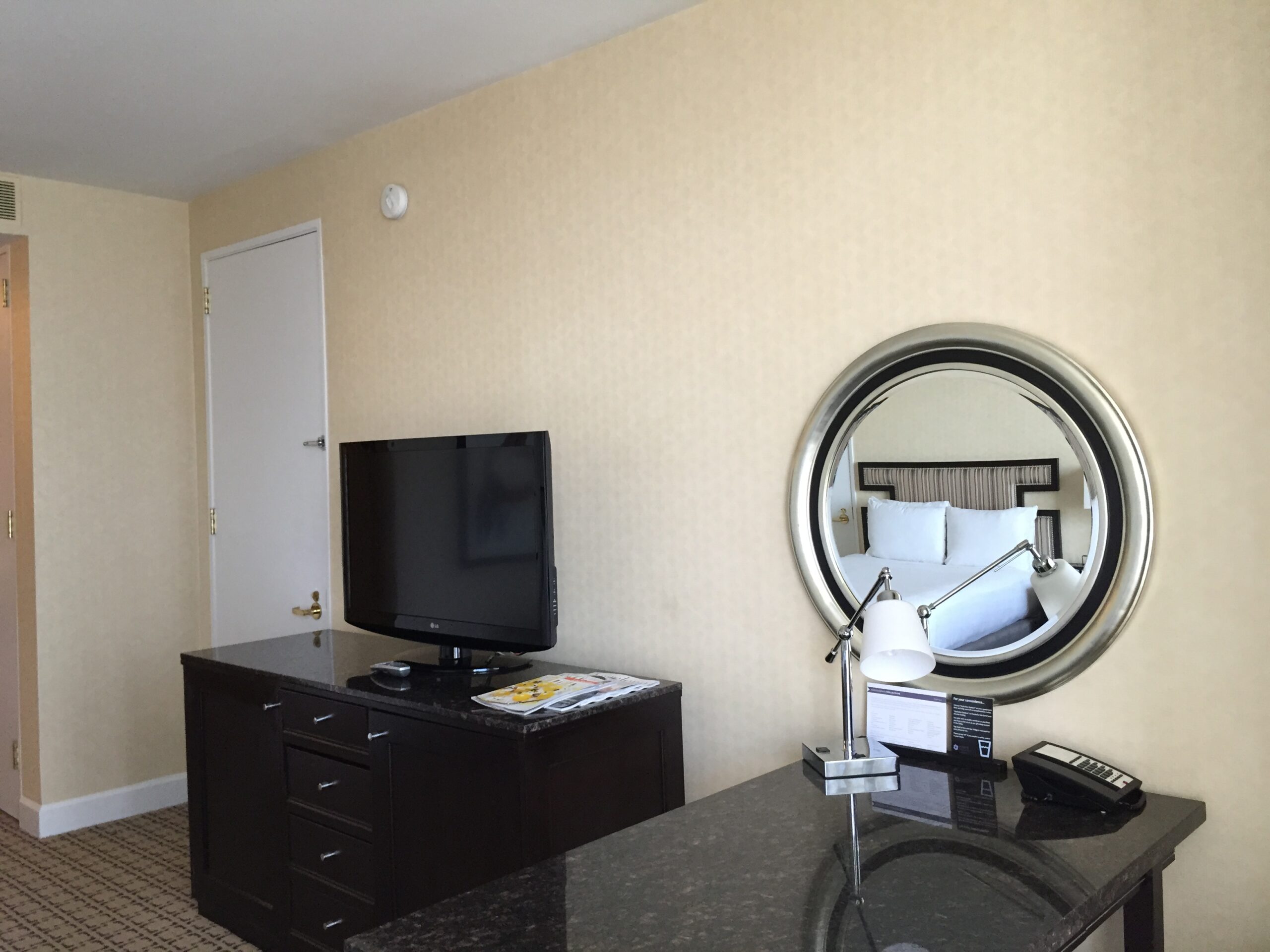a room with a mirror and a television