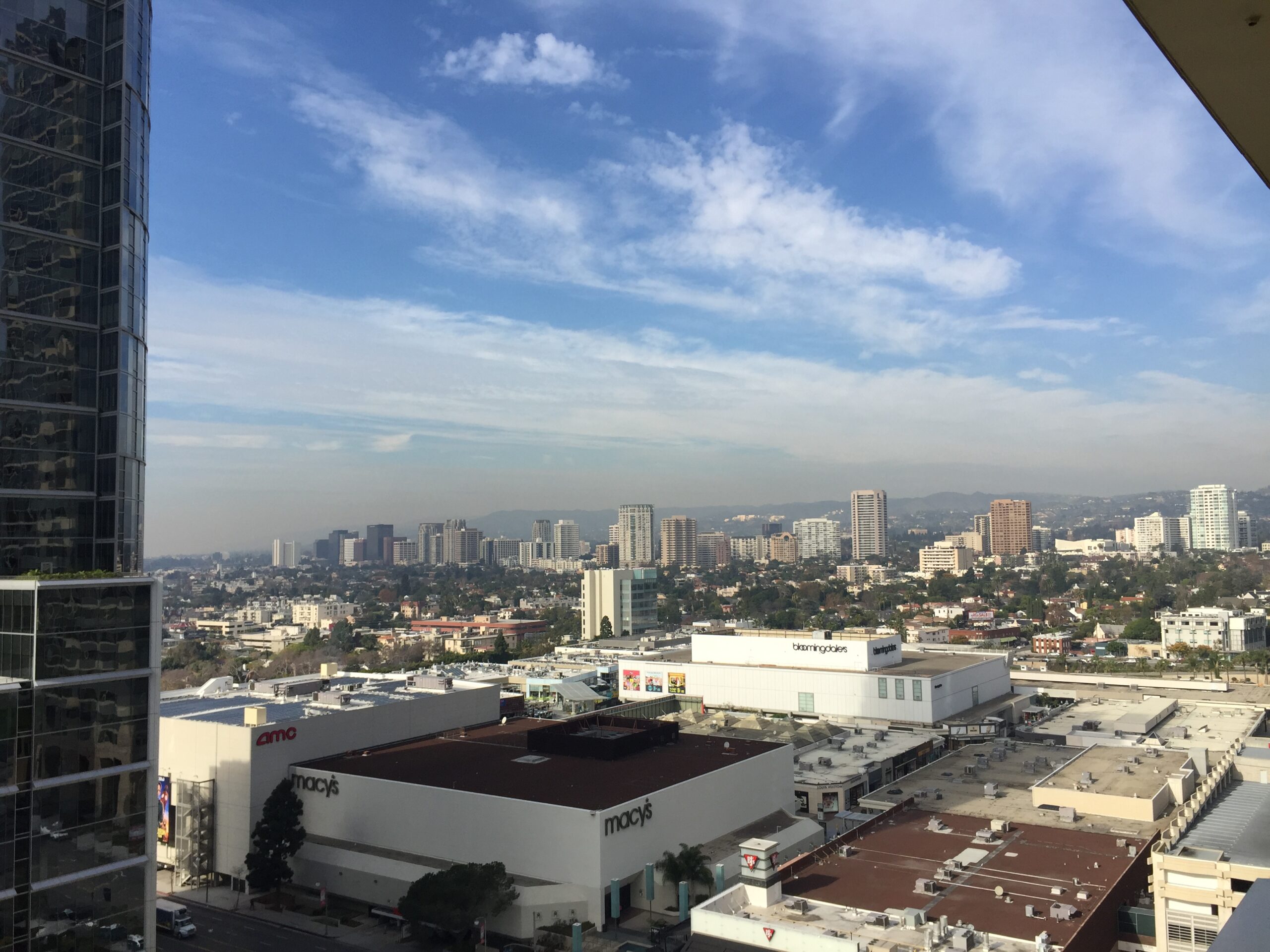 a city with a lot of buildings and a blue sky