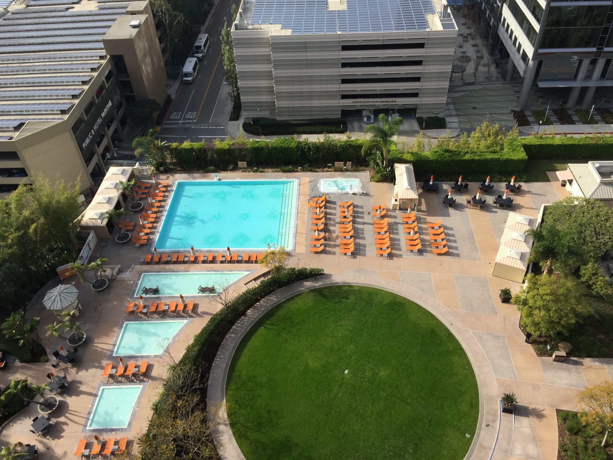 a pool and a building with a parking garage