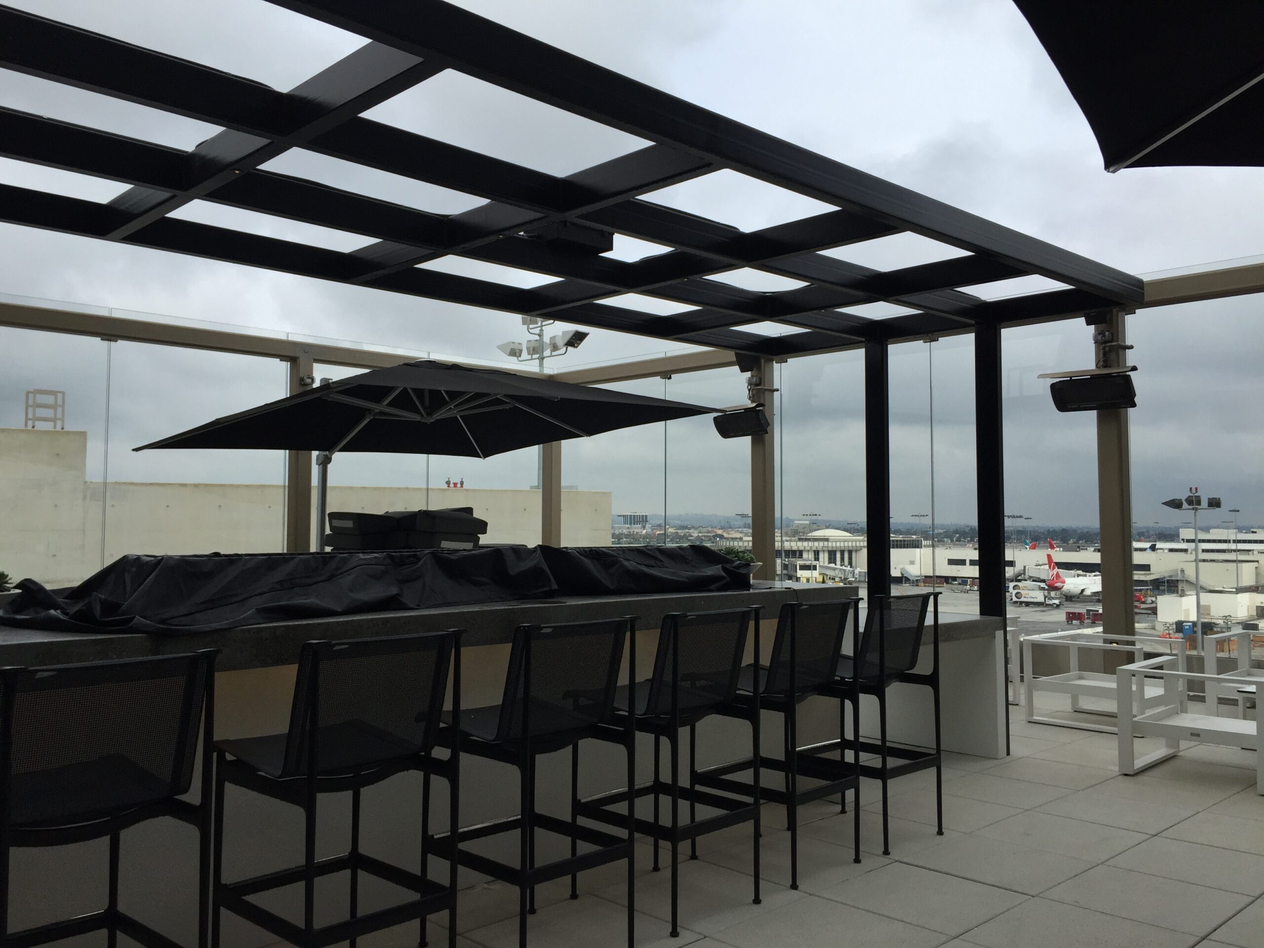 a patio with a bar and chairs