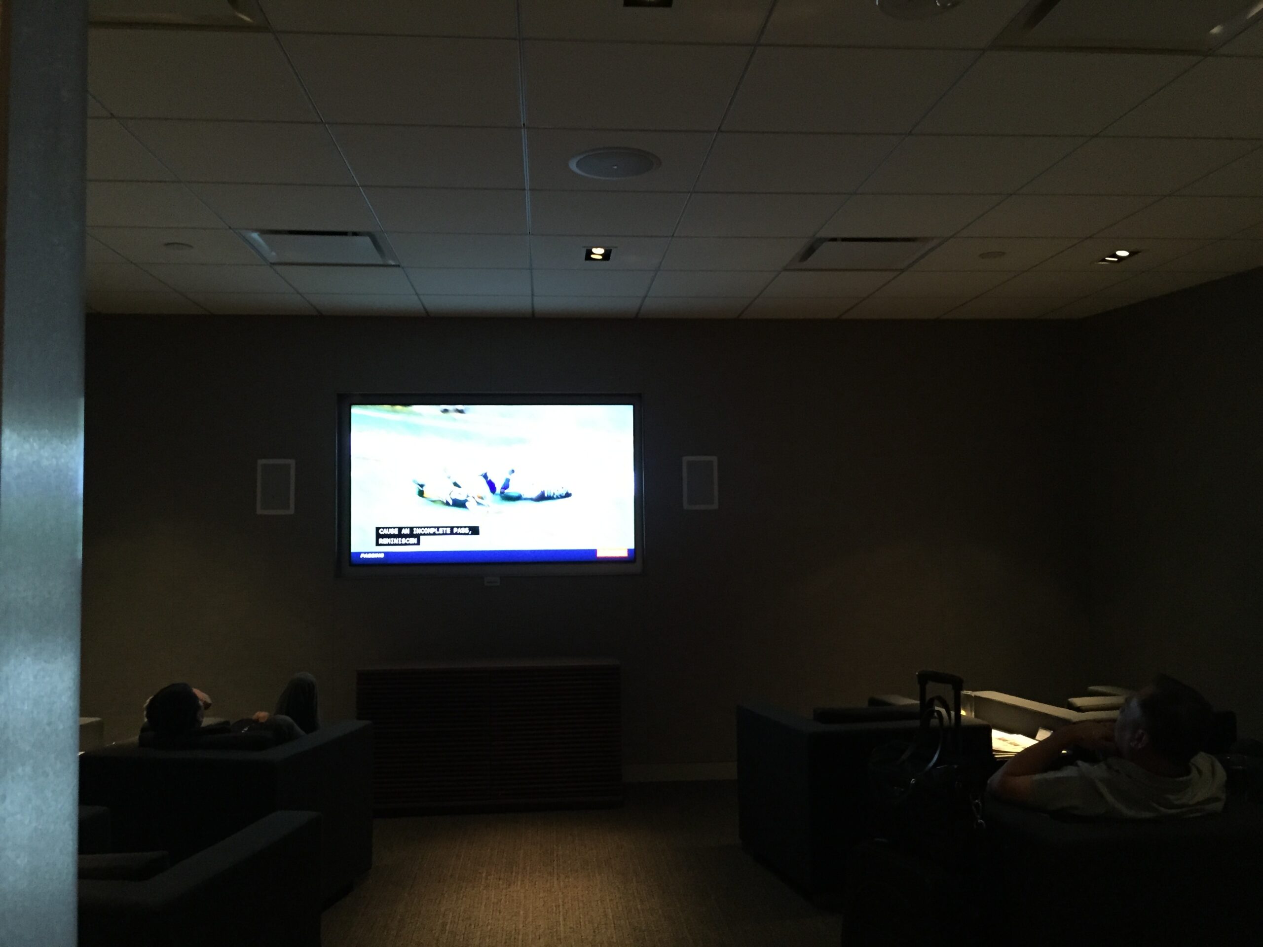 a room with a large screen and a television